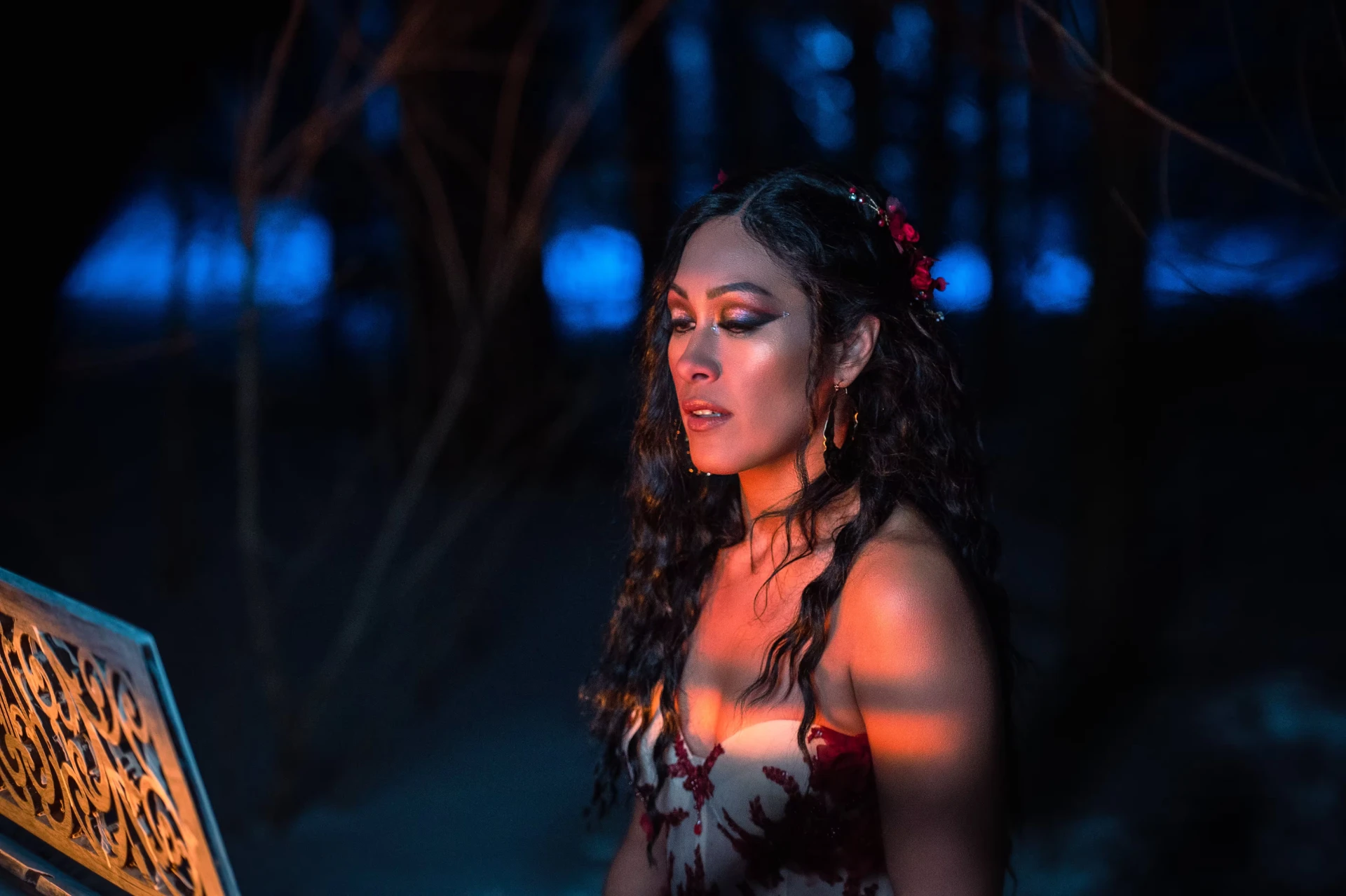 Melina Soochan in a red gown in a winter landscape